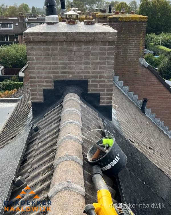 Schoorsteen met loodaansluiting en nokvorst op pannendak in Naaldwijk Schoorsteen met loodaansluiting en nokvorst op pannendak in Naaldwijk