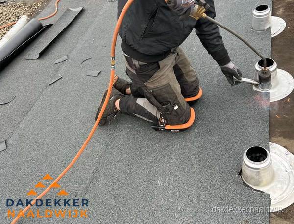 Dakdekker repareert bitumen dakleer bij dakdoorvoer in Naaldwijk